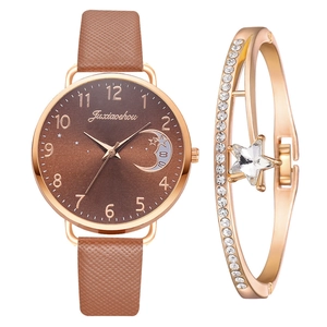 Detail of a brown leather watch with moon-star dial and matching crystal star bracelet
