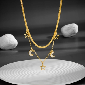 Double-layered gold stainless steel necklace featuring star moon pendants with white shell