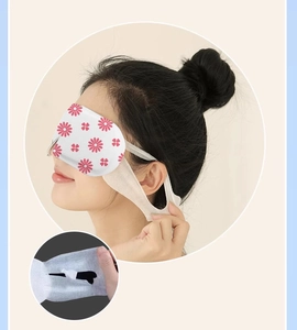 Detail of floral steam eye mask on person showing high-elastic ear straps and soft fabric