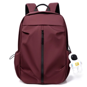 Stylish burgundy travel backpack with a trendy astronaut pendant and sleek black zipper