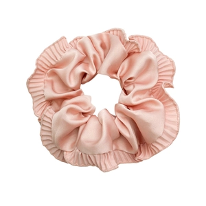 Pink ruffled satin scrunchie for women featuring soft silk texture and wavy edges