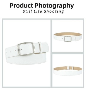 Macro detail of white minimalist belt showing silver square buckle and smooth texture