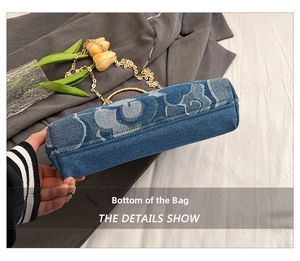 Detail view showing flat bottom construction and cloud pattern on denim crossbody bag