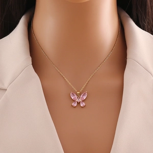 Elegant gold stainless steel necklace with a pink transparent butterfly pendant on model