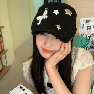 Japanese style black beret hat with white bow and silver stars decoration on model