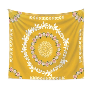 Close-up of mustard yellow mandala tapestry with pink rose floral pattern and leaf details