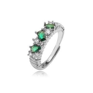 Detail of silver adjustable ring with green gems and white zircons on white background