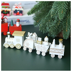 Close-up of a white and gold wooden Christmas train set with bear and snowman figures
