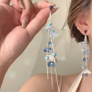 Elegant long fringe earrings with gradient blue flower beads and silver tassels