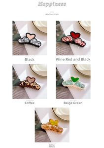 Detail showing acetate heart hair claws in black, wine red, coffee, green, and amber colors