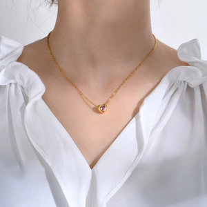 18K gold stainless steel heart necklace with pink zircon pendant worn on model