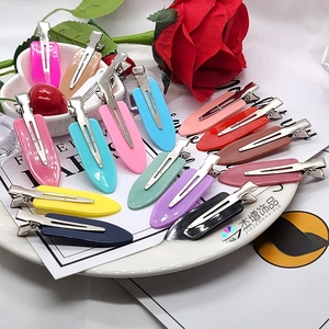 Flat lay of 6cm seamless hair clips in assorted macaron and dark colors on a white tray