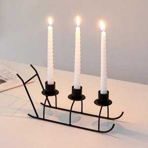 Modern black metal sled-style 3-wick candle holder for Christmas table decor