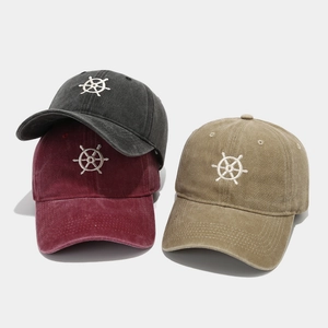Detailed embroidery of rudder pattern on washed cotton baseball caps in multiple colors