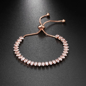 Detail of rose gold marquise-cut tennis bracelet with adjustable bolo clasp and stones