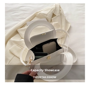 Internal storage view of white handbag showing space for a phone and a short wallet