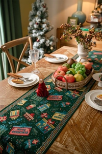 Detailed pattern of a green Christmas table runner with festive Merry Christmas embroidery