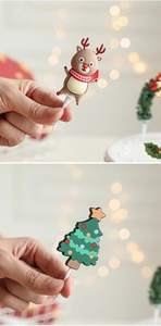 Detail view of festive silicone reindeer and Christmas tree cake toppers with bokeh background