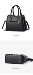 Detail view of the back zipper pocket and gold metal feet on a black printed handbag