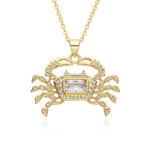 Macro view of gold crab pendant featuring rectangular main stone and pave zircon details
