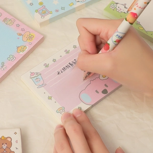 Handwriting on cute cartoon memo pads with dog and sheep patterns for daily journaling