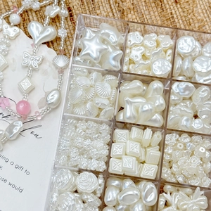 12-grid set of white baroque imitation pearl beads in star shell and heart shapes