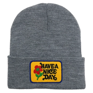 Detail of grey knitted beanie with Have a Nice Day yellow patch embroidery texture