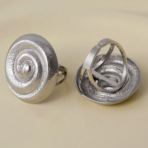 Macro detail of silver adjustable spiral vortex rings with 304 stainless steel texture