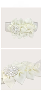 Detail of cream elastic belt with 3D fabric flower and elegant pearl center