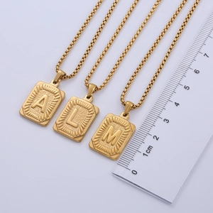 Detail of 18k gold plated rectangular initial pendants with diamond cut edges and box chain