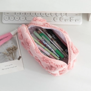 Spacious pink plush pencil case with textured fleece fabric showing colorful markers inside