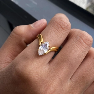 Marquise cut cubic zirconia ring with gold-plated streamlined band on a hand