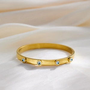 Vintage gold stainless steel bangle with colorful zircon evil eye patterns on silk