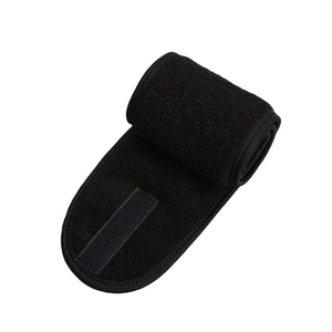 Close-up of black adjustable facial headband with soft texture and secure fastener