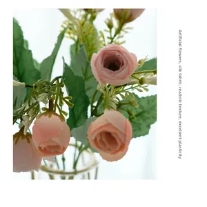 Macro shot of pink silk rose buds with realistic texture in a glass vase