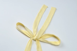 Detail of the yellow knot and tie-up structure on the sexy summer cutout maxi dress