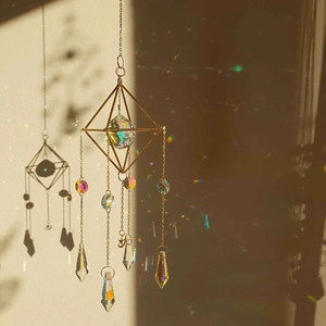 Macro detail of crystal suncatcher snowflake with rainbow light reflections on wall