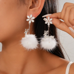 Christmas reindeer earrings with diamond snowflake and white fluffy pom pom on model