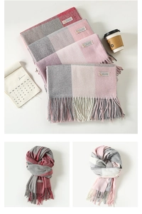 Close-up of soft plaid knit scarves with fringe detailing and warm color block patterns