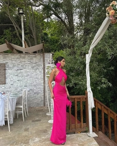 Detail of fuchsia bodycon dress featuring halter neck cut-outs and ruched waist fabric