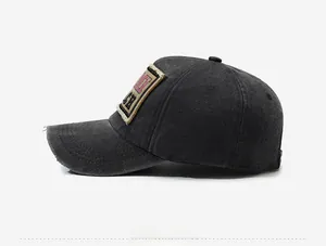 Detailed side view of washed cotton baseball cap with vintage distressed brim and embroidery