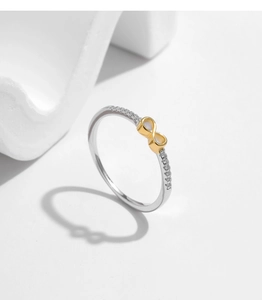 Detail of silver ring featuring golden infinity symbol set with sparkling white diamonds