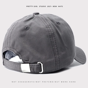 Rear view of a grey vintage soft top baseball cap with an adjustable metal buckle strap