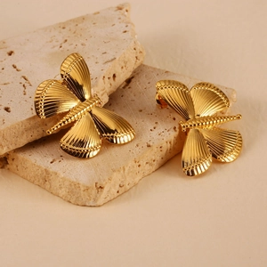Detail of dragonfly earrings in 18K gold-plated stainless steel with brushed texture