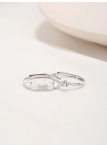 Detailed macro view of S925 sterling silver couple rings with cubic zirconia inlay