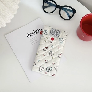 Quilted cartoon cat sunglasses pouch with red button closure on a lifestyle desk setup