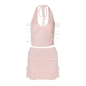 Detailed flat lay of pink halter top and ruched mini skirt set with ruffled hemline