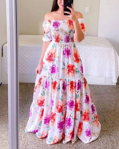 Close-up of elastic shirred bodice on off-shoulder white floral maxi dress