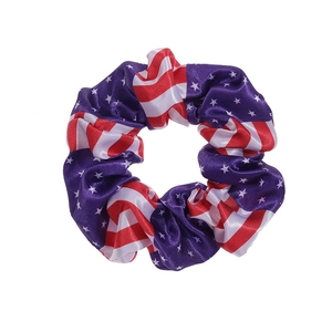 Detailed view of American flag pattern scrunchie with silky satin texture and vivid colors