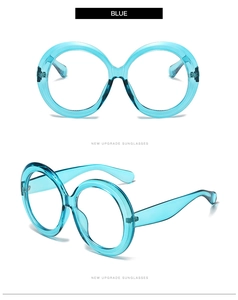 Detail view of oversized round blue sunglasses frame with transparent resin finish